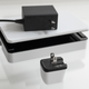 The Human Things Genki Covert Dock Mini sitting next to the Nintendo Switch OLED's dock and charger.